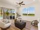 Bright living room with tile floor, large arched window, and sliding door to the outdoor kitchen at 7144 Ashland Gln, Lakewood Ranch, FL 34202