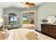 Bright main bedroom with views of the pool, wood floors, and an elegant dresser at 7144 Ashland Gln, Lakewood Ranch, FL 34202