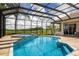 Screened-in pool and spa with view to the golf course on a clear day at 7144 Ashland Gln, Lakewood Ranch, FL 34202
