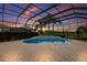 Screened-in pool and spa with view of golf course at sunset at 7144 Ashland Gln, Lakewood Ranch, FL 34202