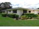 Well-maintained home exterior with manicured hedges and lush green lawn at 7157 Fairway Bend Cir, Sarasota, FL 34243