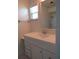 Bathroom with white vanity and mirror, complemented by a window for natural light at 7157 Fairway Bend Cir, Sarasota, FL 34243