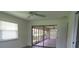 Bedroom with wood floors, window, and access to sunroom at 7157 Fairway Bend Cir, Sarasota, FL 34243