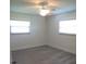 This bedroom has gray plank flooring, a ceiling fan and natural light from the windows at 7157 Fairway Bend Cir, Sarasota, FL 34243