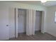 Bedroom featuring closets with bifold doors and built-in organization systems at 7157 Fairway Bend Cir, Sarasota, FL 34243