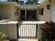 Charming entryway courtyard with a decorative iron gate, and beautiful plants at 7157 Fairway Bend Cir, Sarasota, FL 34243