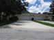 Well-maintained home exterior featuring a spacious driveway and two-car garage at 7157 Fairway Bend Cir, Sarasota, FL 34243