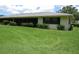 Exterior of home features screened in lanai, manicured landscaping, and a well-kept lawn at 7157 Fairway Bend Cir, Sarasota, FL 34243