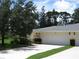 Beautiful home featuring a well-manicured lawn and an inviting front entrance with a two-car garage at 7157 Fairway Bend Cir, Sarasota, FL 34243