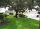 Charming single-story home featuring a lush green lawn and mature shade tree at 7157 Fairway Bend Cir, Sarasota, FL 34243