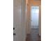 Hallway with neutral colors, tile flooring, and white doors leading to other rooms at 7157 Fairway Bend Cir, Sarasota, FL 34243