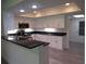 Bright kitchen with stainless steel appliances, granite counters, and white cabinets at 7157 Fairway Bend Cir, Sarasota, FL 34243