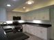 Kitchen featuring stainless appliances, granite counters, sink and many white cabinets at 7157 Fairway Bend Cir, Sarasota, FL 34243