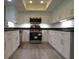 Kitchen with stainless steel appliances, granite counters, and white cabinets at 7157 Fairway Bend Cir, Sarasota, FL 34243