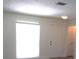 Bright living room featuring a window for natural light and a white painted entry door at 7157 Fairway Bend Cir, Sarasota, FL 34243