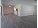 Bright living room featuring modern flooring and open view to kitchen with breakfast bar at 7157 Fairway Bend Cir, Sarasota, FL 34243