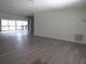 Spacious living room with new flooring, leading to a lanai with sliding glass doors at 7157 Fairway Bend Cir, Sarasota, FL 34243