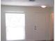 Neutral living room with window and white door with hardware at 7157 Fairway Bend Cir, Sarasota, FL 34243