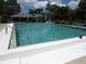 Inviting community pool with clear blue water and comfortable lounge chairs nearby at 7157 Fairway Bend Cir, Sarasota, FL 34243
