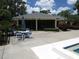 The screened in community clubhouse is conveniently located near the pool with tables and chairs for residents at 7157 Fairway Bend Cir, Sarasota, FL 34243