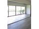 Sunroom with tile floor and glass windows showcasing outdoor greenery at 7157 Fairway Bend Cir, Sarasota, FL 34243