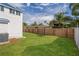 Private backyard features lush green grass, and a wooden fence at 719 22Nd W St, Bradenton, FL 34205