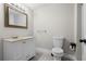 Bathroom features a white vanity with cream countertop, a large mirror and a standard toilet at 719 22Nd W St, Bradenton, FL 34205