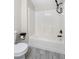 Bathroom with white tub and tile surround, black fixtures, and a standard toilet at 719 22Nd W St, Bradenton, FL 34205