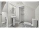 Small bathroom featuring a pedestal sink, classic mirror, and open shelving at 719 22Nd W St, Bradenton, FL 34205