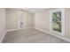 This bedroom features a window view, gray vinyl floors, neutral paint, and an en-suite bath at 719 22Nd W St, Bradenton, FL 34205