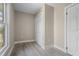 Neutral bedroom showcasing gray wood-look floors, window view, and closet at 719 22Nd W St, Bradenton, FL 34205