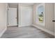 Bright bedroom featuring gray wood-look floors, and a window offering neighborhood views at 719 22Nd W St, Bradenton, FL 34205