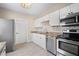 Modern kitchen featuring stainless steel appliances, white cabinets, and stylish subway tile backsplash at 719 22Nd W St, Bradenton, FL 34205
