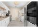 Stylish kitchen with white cabinetry, subway tile backsplash, granite countertops, and stainless steel appliances at 719 22Nd W St, Bradenton, FL 34205