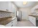 Well-lit kitchen featuring white cabinetry, granite countertops, and new stainless steel appliances at 719 22Nd W St, Bradenton, FL 34205