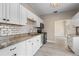 Modern kitchen featuring white cabinets, granite countertops, subway tile, and stainless steel appliances at 719 22Nd W St, Bradenton, FL 34205