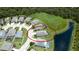 Detailed aerial shot showcasing home's location, backing to greenery and water with pool view at 7364 47Th Avenue E Cir, Bradenton, FL 34203