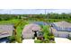 Aerial view of a single-Gathering home with a well-manicured lawn and scenic pond views at 7364 47Th Avenue E Cir, Bradenton, FL 34203