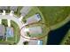 Aerial view of a home with a well-maintained lawn and a tranquil pond in a desirable neighborhood at 7364 47Th Avenue E Cir, Bradenton, FL 34203