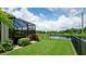 Lush backyard featuring a screened-in lanai with manicured landscaping, offering a tranquil and private outdoor space at 7364 47Th Avenue E Cir, Bradenton, FL 34203
