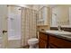 Bathroom with a tub/shower combination, patterned shower curtain, and vanity with granite countertop at 7364 47Th Avenue E Cir, Bradenton, FL 34203