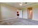 Spacious bedroom featuring neutral colors, a ceiling fan, and access to other rooms at 7364 47Th Avenue E Cir, Bradenton, FL 34203