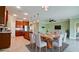 Open concept dining and kitchen area with stainless steel appliances and modern light fixtures at 7364 47Th Avenue E Cir, Bradenton, FL 34203