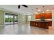 Spacious kitchen featuring a central island, tile flooring, and sliding door access to the lanai at 7364 47Th Avenue E Cir, Bradenton, FL 34203