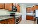 Well-equipped kitchen with stainless steel appliances, granite countertops, and ample cabinet space at 7364 47Th Avenue E Cir, Bradenton, FL 34203