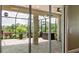 View of screened lanai with tile floor overlooking lush landscaping and mature trees at 7364 47Th Avenue E Cir, Bradenton, FL 34203