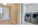 Convenient laundry area with stainless steel washer and dryer, and shelving for storage at 7364 47Th Avenue E Cir, Bradenton, FL 34203