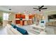 Open concept living room with a view of the kitchen featuring an island, barstools, and pendant lights at 7364 47Th Avenue E Cir, Bradenton, FL 34203