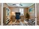 Well-lit home office with a built-in bookcase, a desk, and a window with plantation shutters at 7364 47Th Avenue E Cir, Bradenton, FL 34203