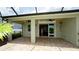 Covered patio features brick flooring, fan, and sliding glass doors leading indoors at 7364 47Th Avenue E Cir, Bradenton, FL 34203